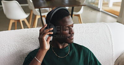 Buy stock photo Home, headphones and black man on sofa, thinking and listening to music, song and podcast. Calm, relax and African person on couch, audio or radio with sound, subscription or playlist album in lounge