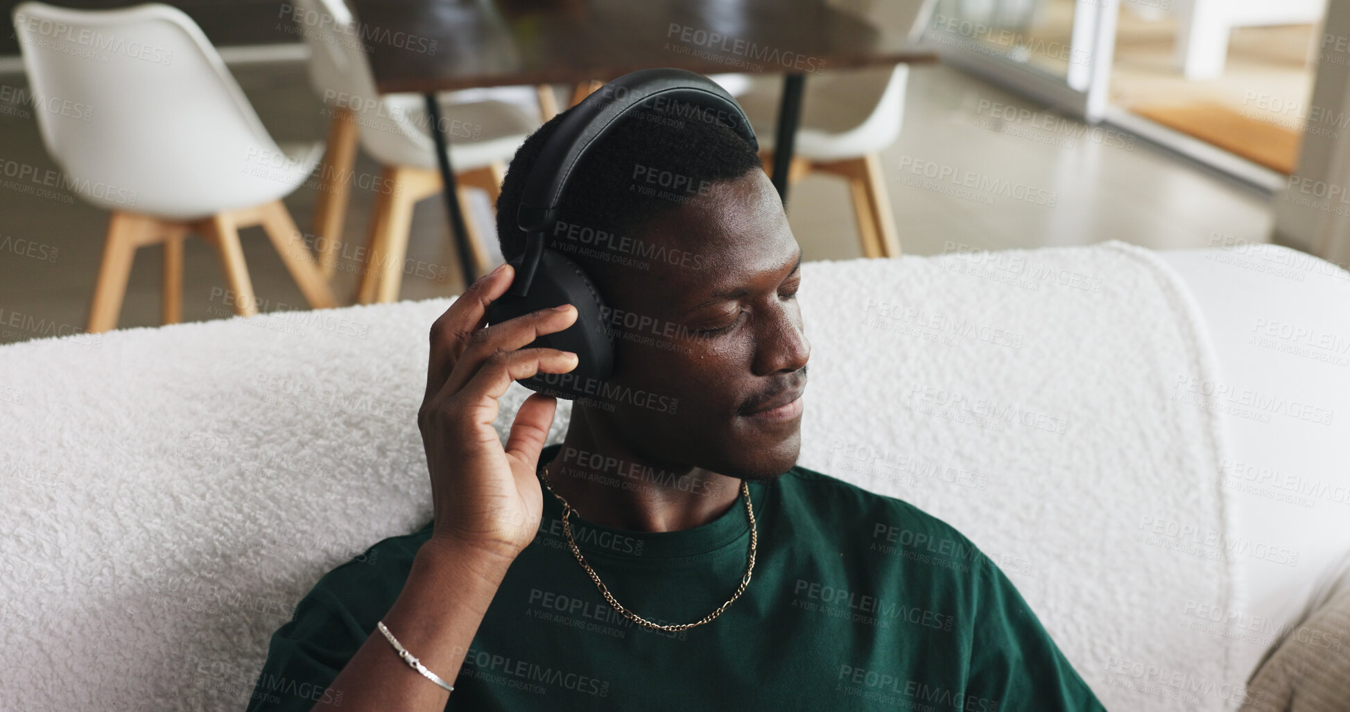 Buy stock photo Home, headphones and black man on sofa, thinking and listening to music, song and podcast. Calm, relax and African person on couch, audio or radio with sound, subscription or playlist album in lounge