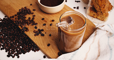 Buy stock photo Ice, coffee and straw in drink on table in kitchen of home for caffeine beverage, breakfast or morning brew. Cappuccino, cold latte and prepare with glass on counter of apartment for liquid and beans