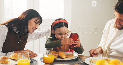 Buy stock photo Breakfast, syrup and morning with family in dining room of home for support, love and nutrition. Food, relax and croissant with parents and child eating pancake in apartment for meal and wellness