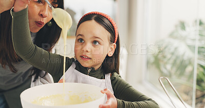 Buy stock photo Baking, mother or kid with batter in kitchen, meal prep or helping with dessert in family home. Learning, check consistency or woman with girl to teach cooking skill, guide or support for development