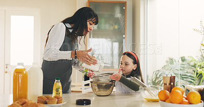 Buy stock photo Baking, mother and kid in kitchen for meal prep, sifting flour or helping with breakfast in family home. Mixing bowl, guide and woman with girl for teaching skills, development or learning in bonding