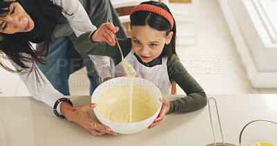 Buy stock photo Baking, mother or kid with batter on kitchen counter, meal prep or help with dessert in family home. Learning, above or woman with girl to teach cooking skill, guide or support for consistency check