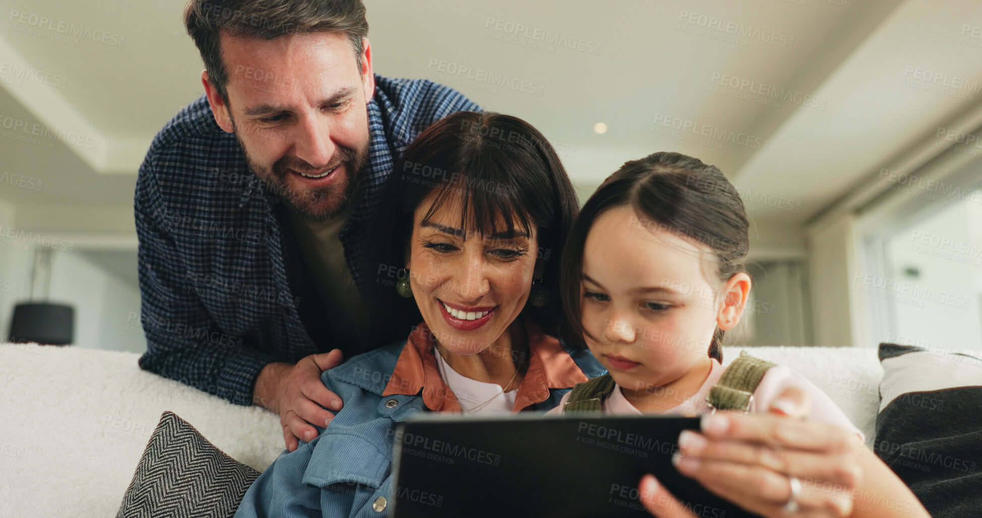 Buy stock photo Tablet, relax and parents with child on sofa in home for playing educational video game on app. Happy, digital technology and girl kid with mom and dad for watching movie in living room at house.