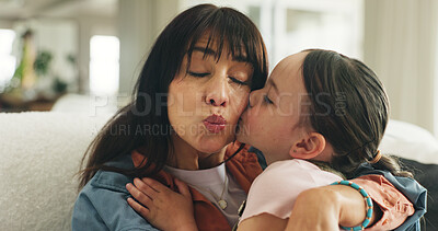 Buy stock photo Relax, kiss and mother with daughter on sofa of family home for bonding, support and love. Connection, happiness and affection with woman and child in living room of apartment for trust and care