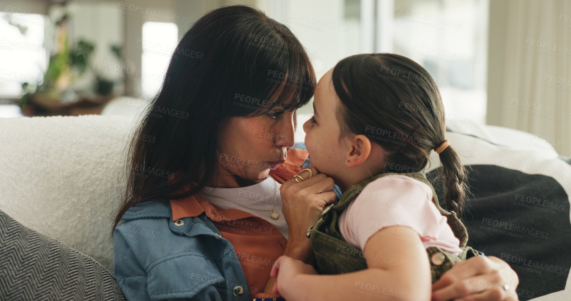 Buy stock photo Relax, love and mother with daughter on sofa of family home for bonding, support and hug. Connection, happiness and affection with woman and child in living room of apartment for trust and care