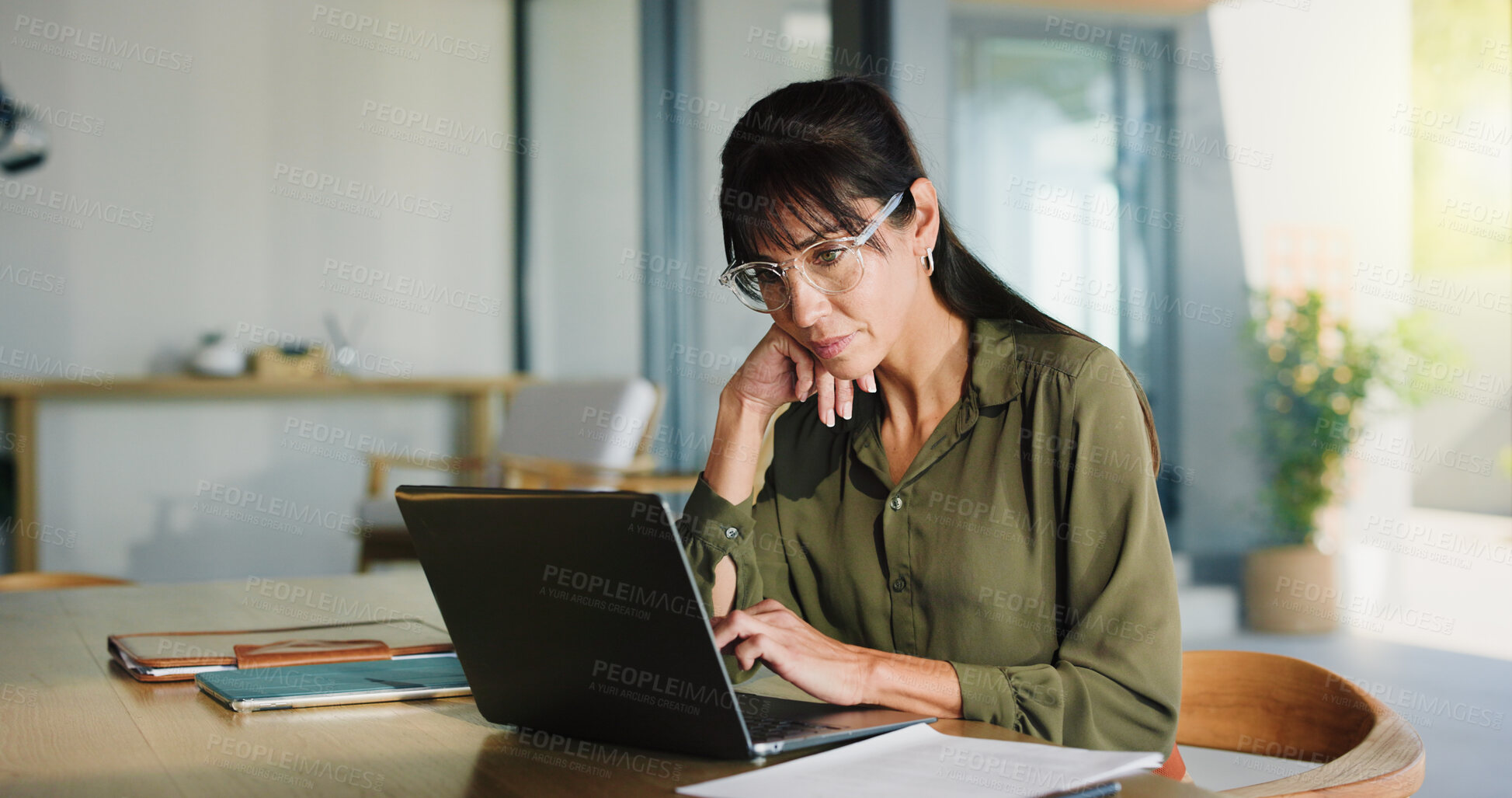 Buy stock photo Woman, remote work and reading with laptop at house for real estate, property report and research. Mature realtor, pc and paperwork for sales agreement, listing information and negotiation statement