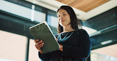 Buy stock photo Woman, realtor and tablet in office for reading, property management and service review. Low angle, estate agent and digital tech in agency for commission update, scroll and smile for research