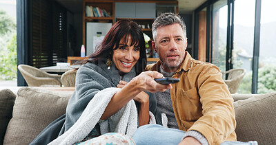 Buy stock photo Relax, couple and watching tv with remote on sofa for film choice, movie search or weekend break. Cozy, happy mature people and television with blanket in home for streaming subscription and bonding