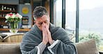 Blowing nose, sick and cold with man on sofa for virus infection, disease recovery and healthcare. Hayfever symptoms, influenza illness and healing with person and blanket in living rom of home