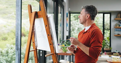 Buy stock photo Painter, think or canvas by window for creativity project, visual expression or inspiration for craft. Home, calm or mature man with brush for reflection, artistic activity or view landscape for idea