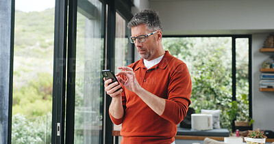 Buy stock photo Man, scroll or reading with phone in home for social media post, internet search or email notification. Mature person, browsing or tech in apartment with mobile app, text message or online networking