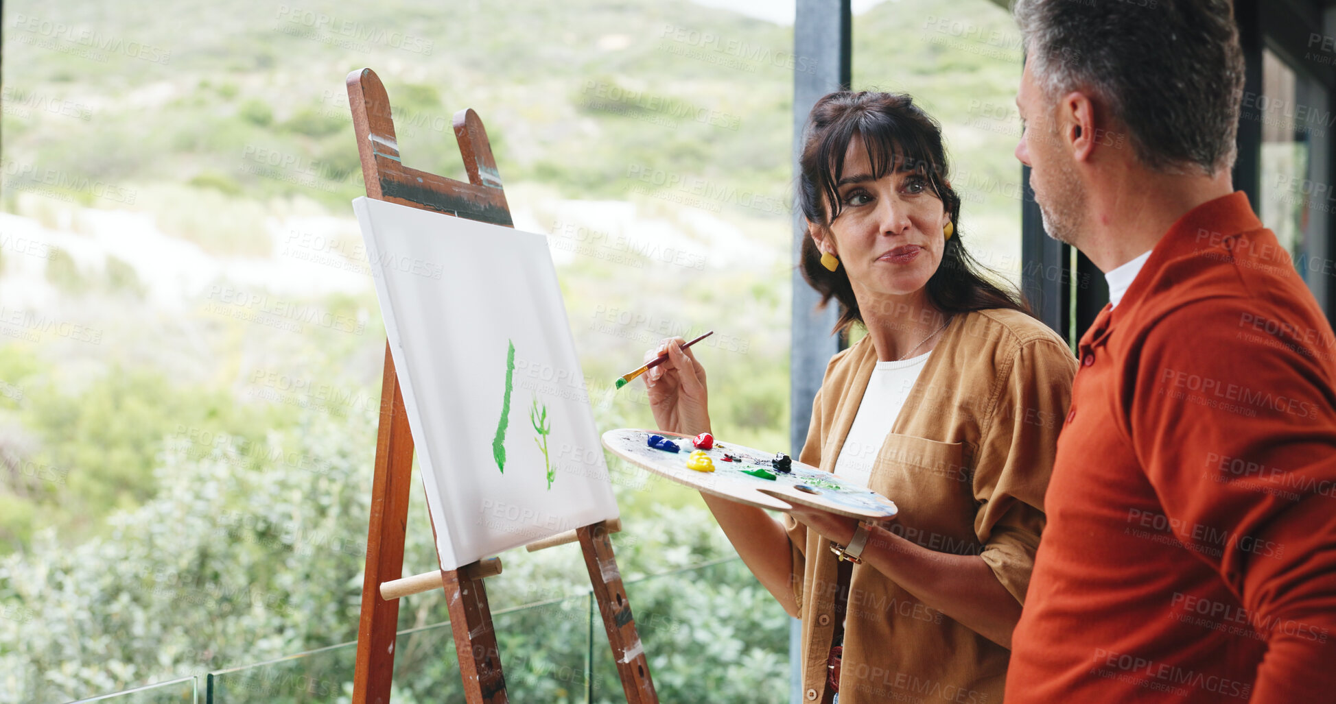 Buy stock photo Canvas, couple and painting at window in home for custom art project, creative activity and support. Happy artist, mature people and easel on balcony for artwork hobby, nature inspiration and bonding