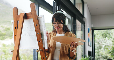 Buy stock photo Painter, home or headphones with canvas for creativity project, self expression or happiness for craft. Tech, streaming music or mature woman with palette for artistic activity, creation or low angle