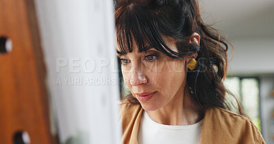Buy stock photo Painting, woman or canvas in home for creativity project, self expression or concentration in craft. Calm, freelancer or mature artist with easel for artistic activity, passion or talent for creation
