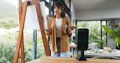 Buy stock photo Painting, phone and live streaming with woman in workshop for design class, artist project and webinar. Online guide, gallery artwork and canvas with mature person in apartment studio for hobby