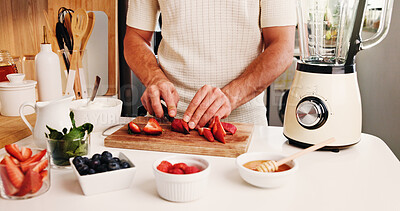 Buy stock photo Hands, cut strawberry and blender on kitchen counter for healthy smoothie, nutrition and vegan diet. Man, chop fruit or ingredients in home with machine for drink, gut health or antioxidant benefits.