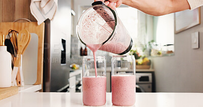Buy stock photo Hand, pour smoothie and glasses in kitchen with blender, organic nutrition and antioxidant benefits. Person, strawberry and protein shake in home with jug for digestive health, hydration or beverage.