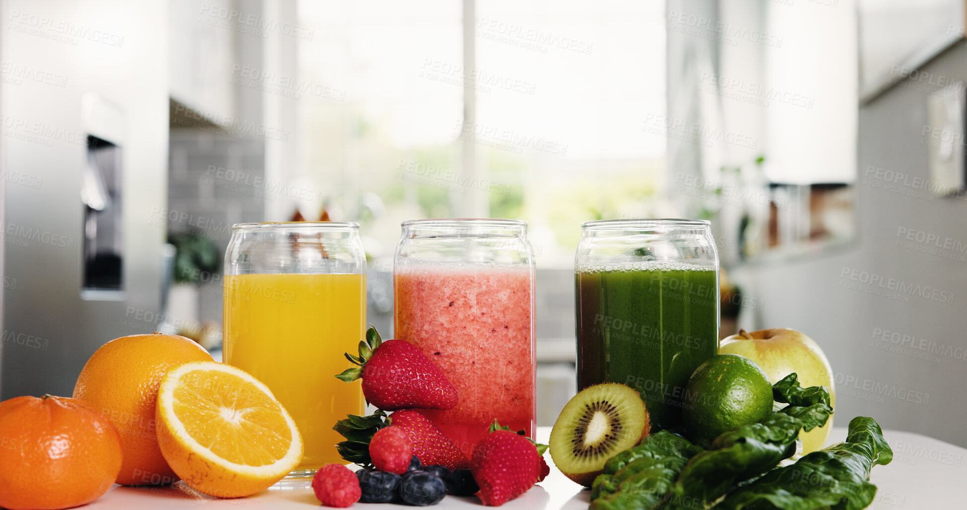 Buy stock photo Organic, fruit juice or glasses in kitchen with range for healthy diet, vitamin or mineral benefits. Orange, strawberry or kiwi drinks in home for digestive health, hydration or natural detox recipe.