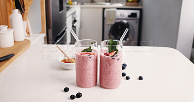 Buy stock photo Strawberry, smoothie or glasses in kitchen with fruit drink, organic nutrition or antioxidant benefits. Honey, blueberry and protein shake in home for digestive health, morning beverage or hydration.