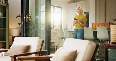 Buy stock photo Mature woman, phone and texting in home with smile, web chat or notification with gossip in living room. Person, smartphone and happy with mobile app, contact and glasses for social network at house
