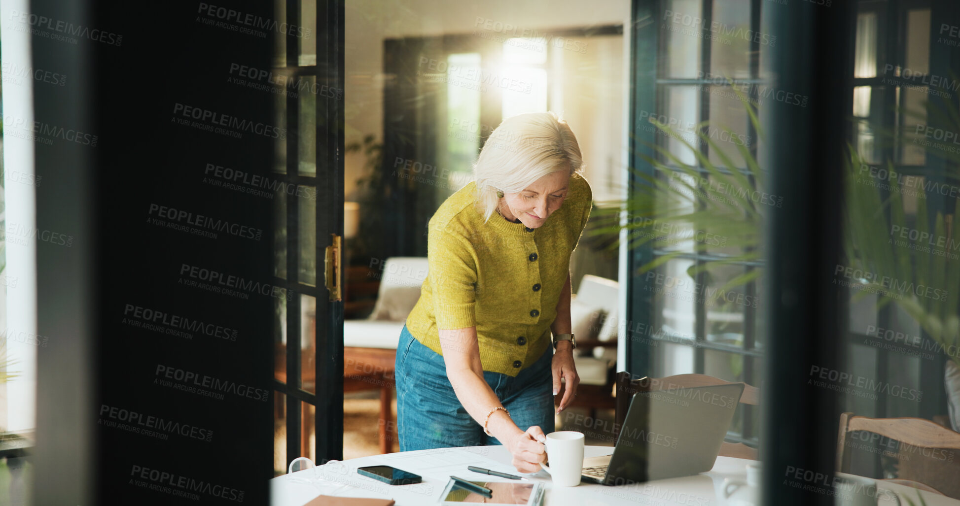 Buy stock photo Mature woman, coffee and remote work with laptop in home for morning or creative business. Female person, freelancer or designer with mug, cup or computer for beverage, drink or caffeine in house