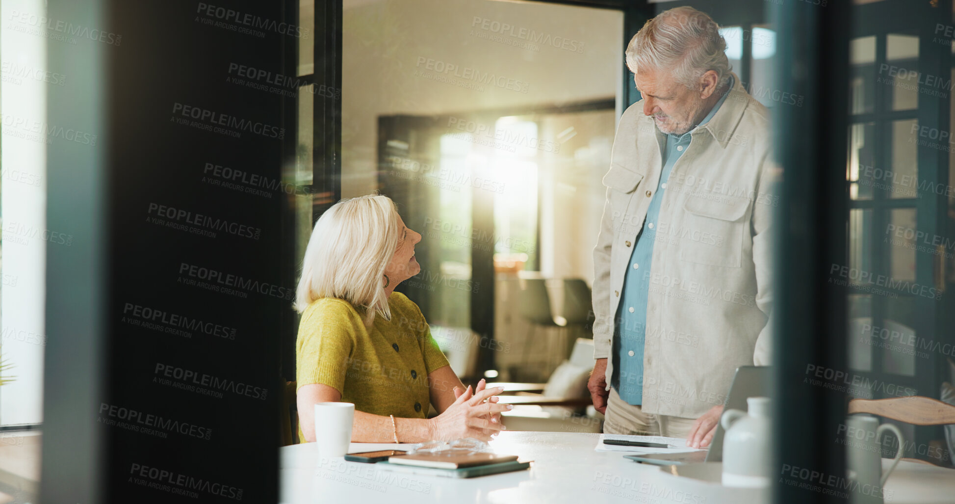 Buy stock photo Senior couple, talking and happy in home, love and planning for retirement with laptop and research. Financial analysis, old woman and discussion with man for pension fund, flare and bonding in house