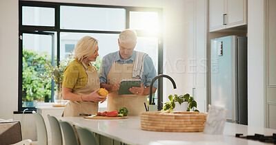Buy stock photo Senior couple, cooking and tablet in kitchen with search, recipe and helping hand for dinner at house. People, vegetables and ingredients with tech, app and tutorial video for nutrition in retirement