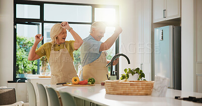 Buy stock photo Senior couple, dancing and happy for cooking in kitchen, recipe and excited for dinner at house. People, vegetables and playful with ingredients, bonding or love with nutrition in retirement home