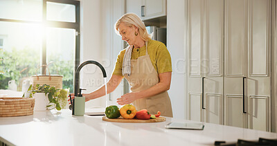 Buy stock photo Senior woman, rinse vegetables and kitchen with cleaning, dirt removal and faucet for dinner at house. Person, wash pepper and ingredients with cooking, diet or hygiene for nutrition in retirement