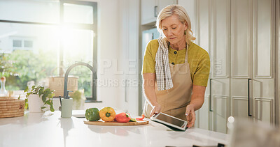 Buy stock photo Senior woman, cooking and tablet in kitchen with search, recipe and online course for dinner at house. Person, vegetables and ingredients with tech, app and tutorial video for nutrition in retirement