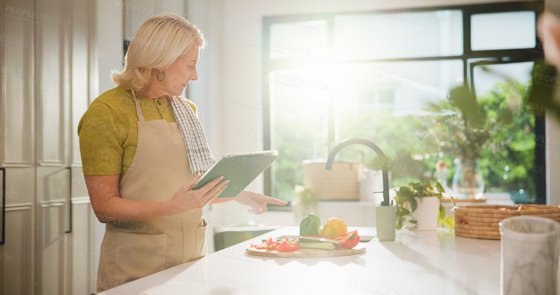 Buy stock photo Senior, woman and cooking with tablet for online tutorial, healthy recipe or tips in kitchen. Elderly, female person or flare with technology or ingredients for natural organic food or meal prep