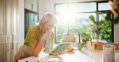 Buy stock photo Senior woman, tablet and happy in kitchen with search, recipe and online course for dinner at house. Person, vegetables and ingredients with flare, app or tutorial video for cooking in retirement