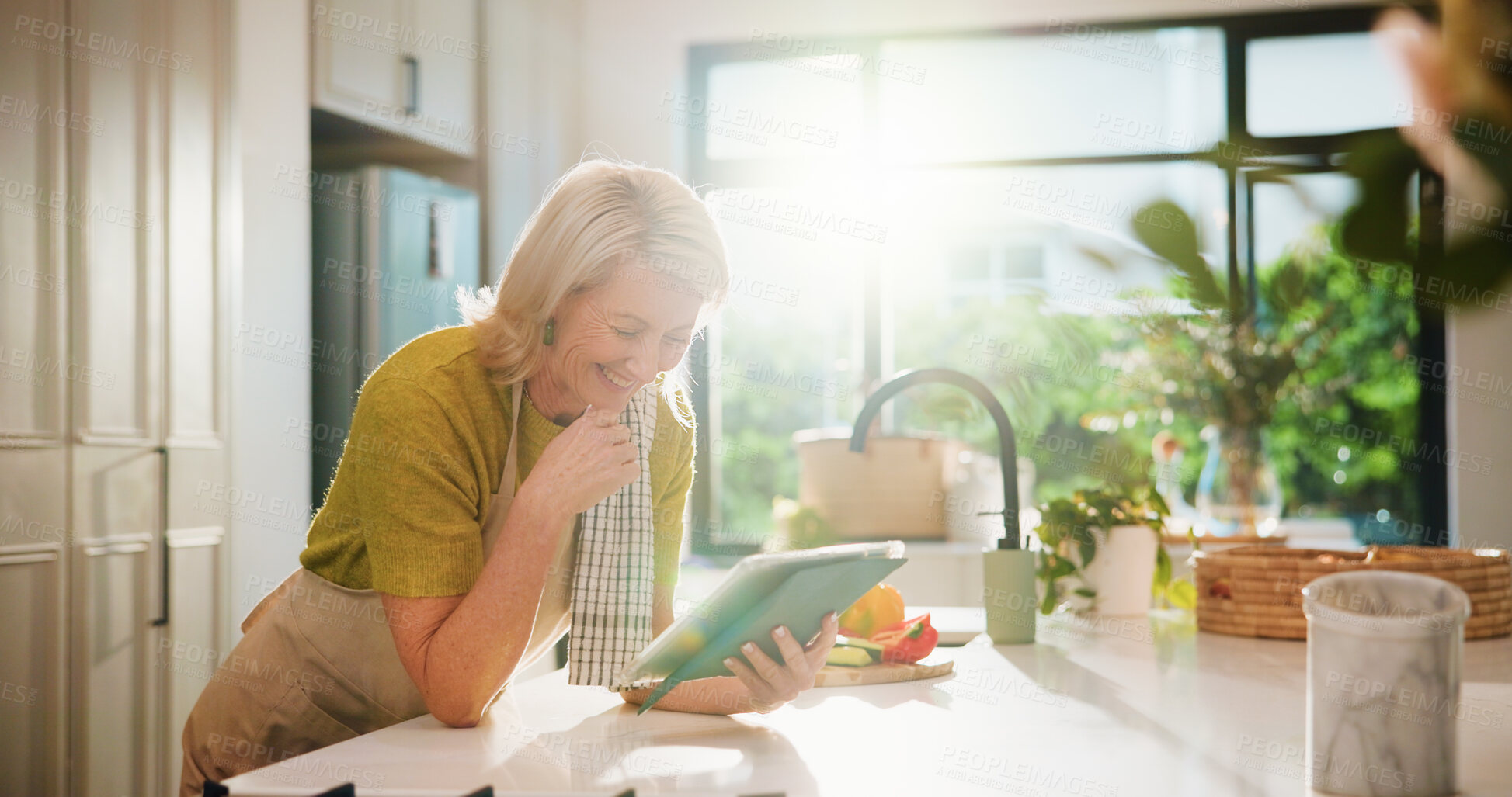 Buy stock photo Senior woman, tablet and happy in kitchen with search, recipe and online course for dinner at house. Person, vegetables and ingredients with flare, app or tutorial video for cooking in retirement