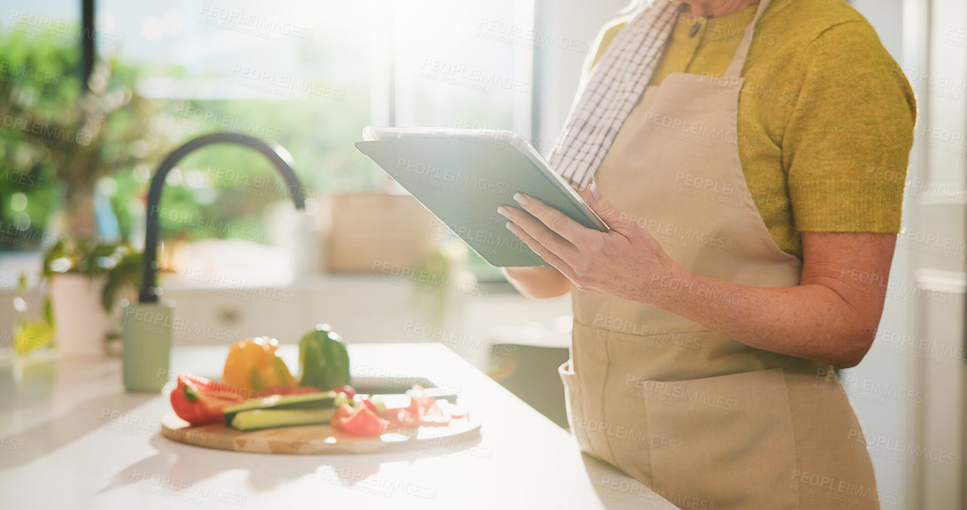Buy stock photo Senior, woman and hands with tablet for online cooking tutorial or healthy recipe in kitchen. Elderly, female person or research with technology or ingredients for natural organic food or meal prep