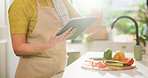Elderly, woman and hands with tablet for online cooking tutorial or healthy recipe in kitchen. Senior, female person or research with technology or ingredients for natural organic food or meal prep