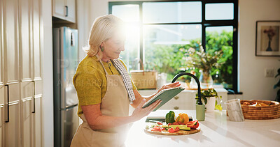 Buy stock photo Elderly, woman and online recipe with tablet for cooking tutorial or healthy food in home kitchen. Senior, female person or flare with technology or ingredients for natural organic snack or meal prep