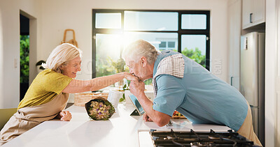 Buy stock photo Old couple, kiss hand and bouquet in kitchen for valentines day, anniversary and celebration at home. Senior people, happy and flare with flowers, loyalty and present for milestone in relationship