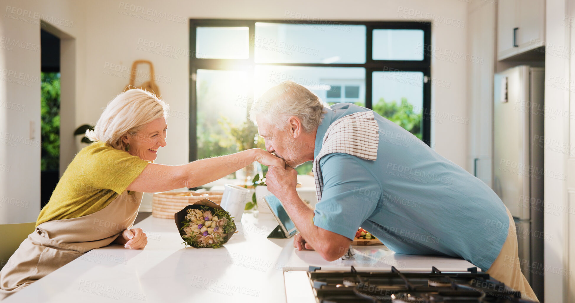 Buy stock photo Old couple, kiss hand and bouquet in kitchen for valentines day, anniversary and celebration at home. Senior people, happy and flare with flowers, loyalty and present for milestone in relationship