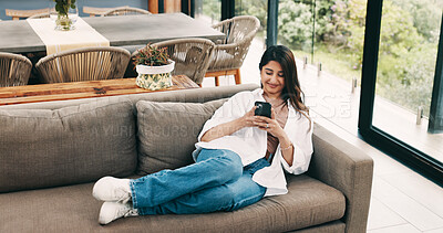 Buy stock photo Smile, woman and relax with phone at house for social media, browsing website and texting contact. Person, resting and mobile to download game, online notification and chat for message update on sofa
