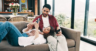 Buy stock photo Smile, couple and relax with phone at house for social media, browsing website and bonding together. People, love and mobile to play games, online notification and reading for message update on sofa