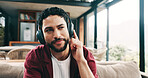Music, relax and thinking with man on sofa in living room of home for me time or wellness. Chilling, headphones and idea with person in apartment for easy morning, inspiration or weekend planning