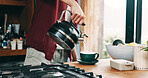 Hand, pouring tea and steam with person in kitchen of home for beverage preparation at counter. Boiling water, cup and kettle with man closeup in apartment for drink, me time routine or wellness