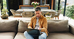 Confused, sofa and mature man on laptop for online review, planning and proofreading for remote work. Author, home and person on computer for editing story, thinking and mistake in living room