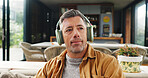 Music, relax and thinking with man on sofa in living room of home for audio or sound streaming. Break, headphones and idea with mature person in apartment for inspiration, playlist or wellness
