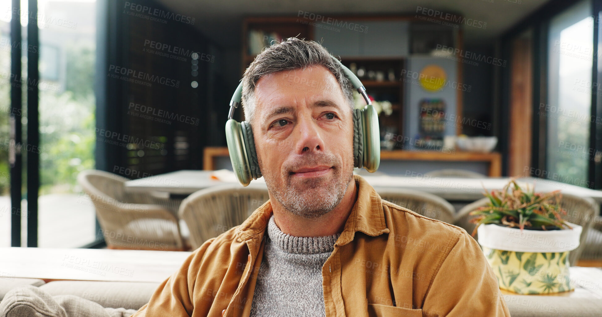 Buy stock photo Music, relax and thinking with man on sofa in living room of home for audio or sound streaming. Break, headphones and idea with mature person in apartment for inspiration, playlist or wellness