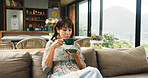 Woman, cup and sofa with tea for morning beverage, fresh start or comfort drink in home. Female person, chill or relax with mug, break or rest for herbal remedy, stress relief or refreshment in house