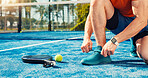 Man, hands and tying shoes on padel court for outdoor match or workout preparation. Wellness, male person and athlete legs getting ready with sneakers, laces and sport for game, fitness or challenge