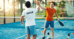 Padel, coach and men on court high five for training, practice and exercise for challenge success. Fitness, personal trainer and people celebrate for game, tennis match and competition outdoor