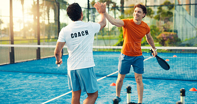 Buy stock photo Padel, coach and men on court high five for training, practice and exercise for challenge success. Fitness, personal trainer and people celebrate for game, tennis match and competition outdoor